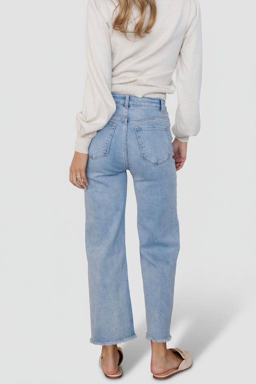 Detail shot of Brody jeans waist and button front, showing fabric composition, topstitching, and the comfortable high-rise fit.