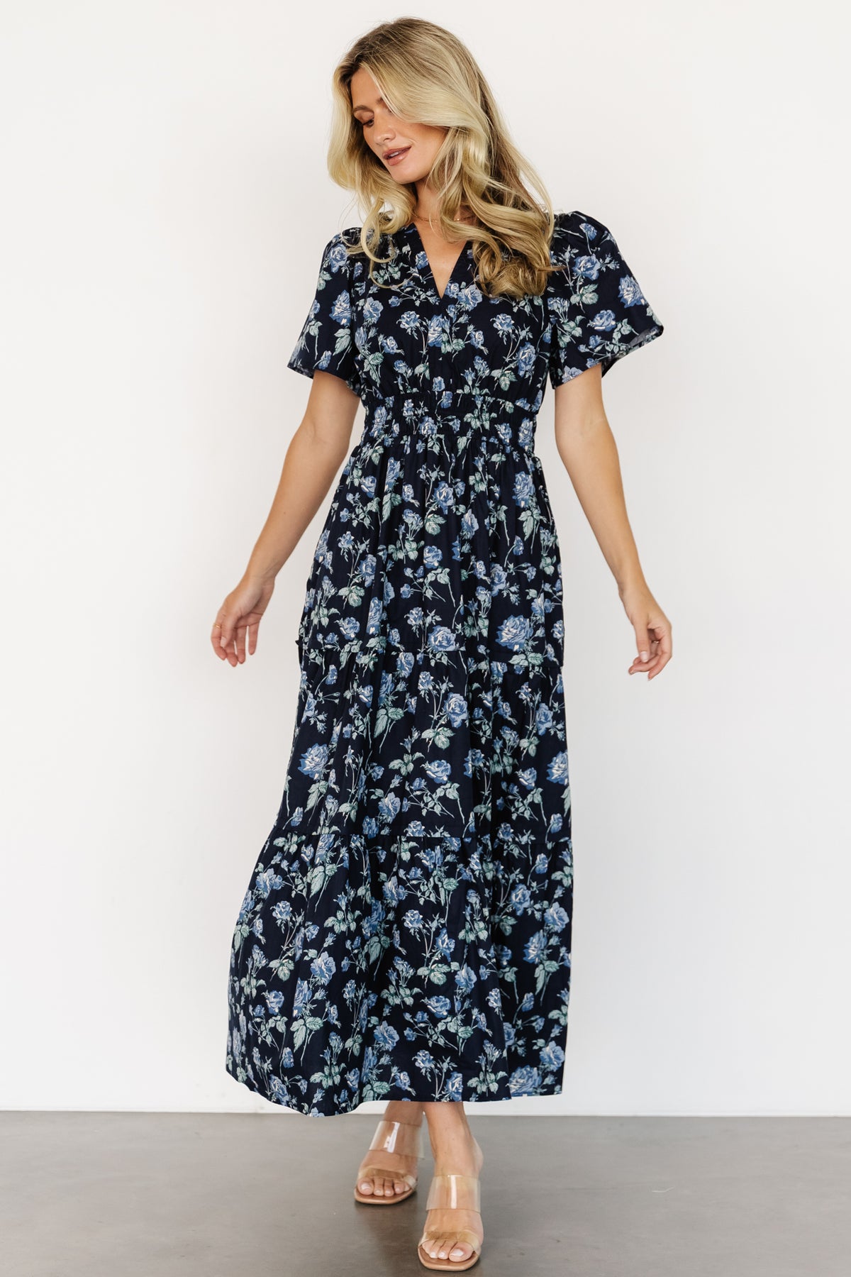 Back and full-length view of Kristin Maxi Dress in navy floral, illustrating the tiered maxi length and natural cotton hang.