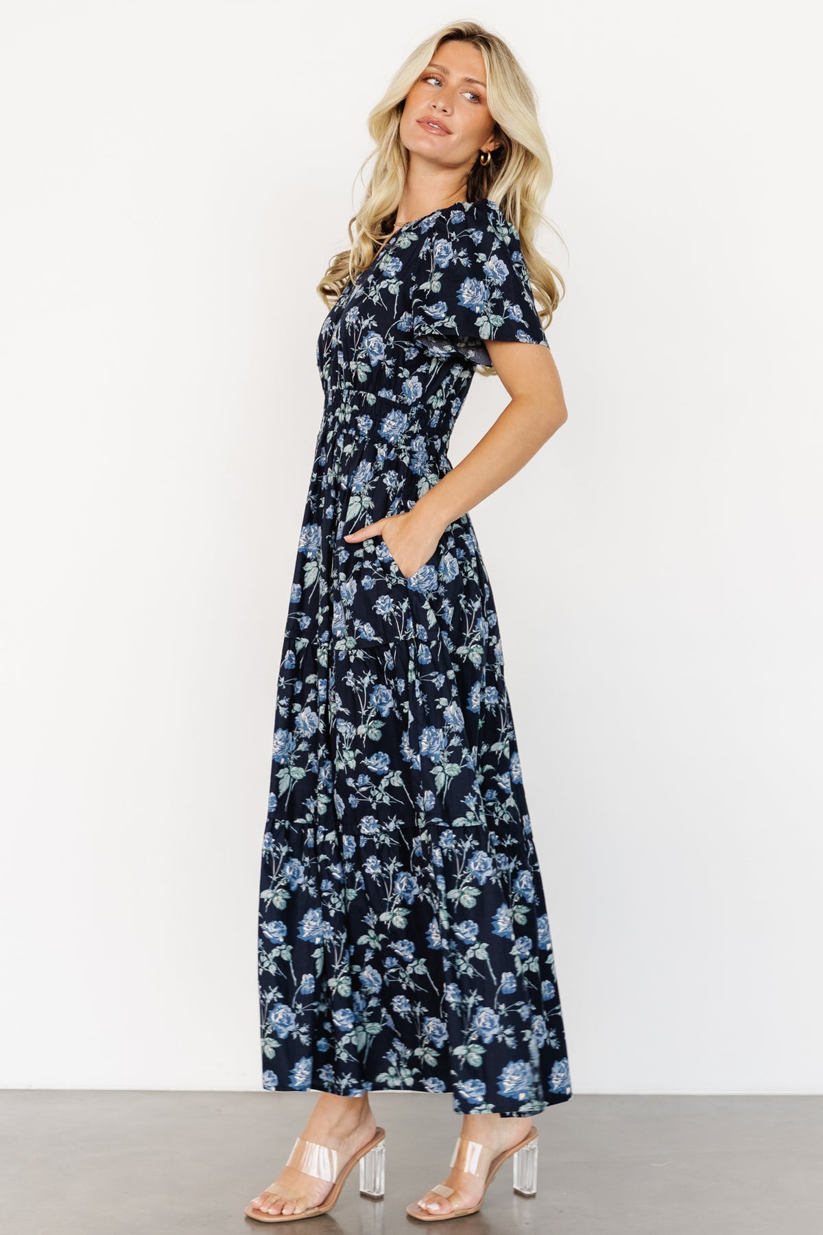 Close-up of Kristin Maxi Dress fabric and pattern showing navy floral print, smocked waist detail and notched V-neck finishing at the bodice.