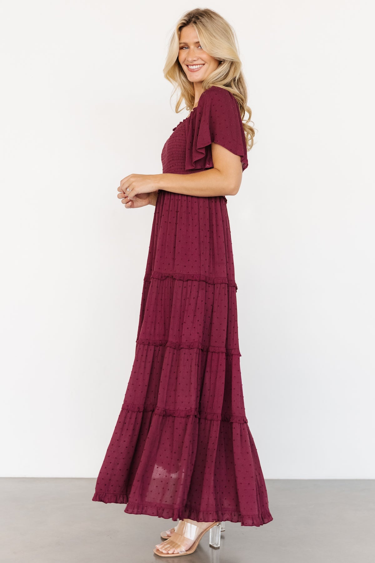Full-length movement photo of the wine Lenora Maxi Dress highlighting tiered ruffle skirt and lightweight rayon drape.