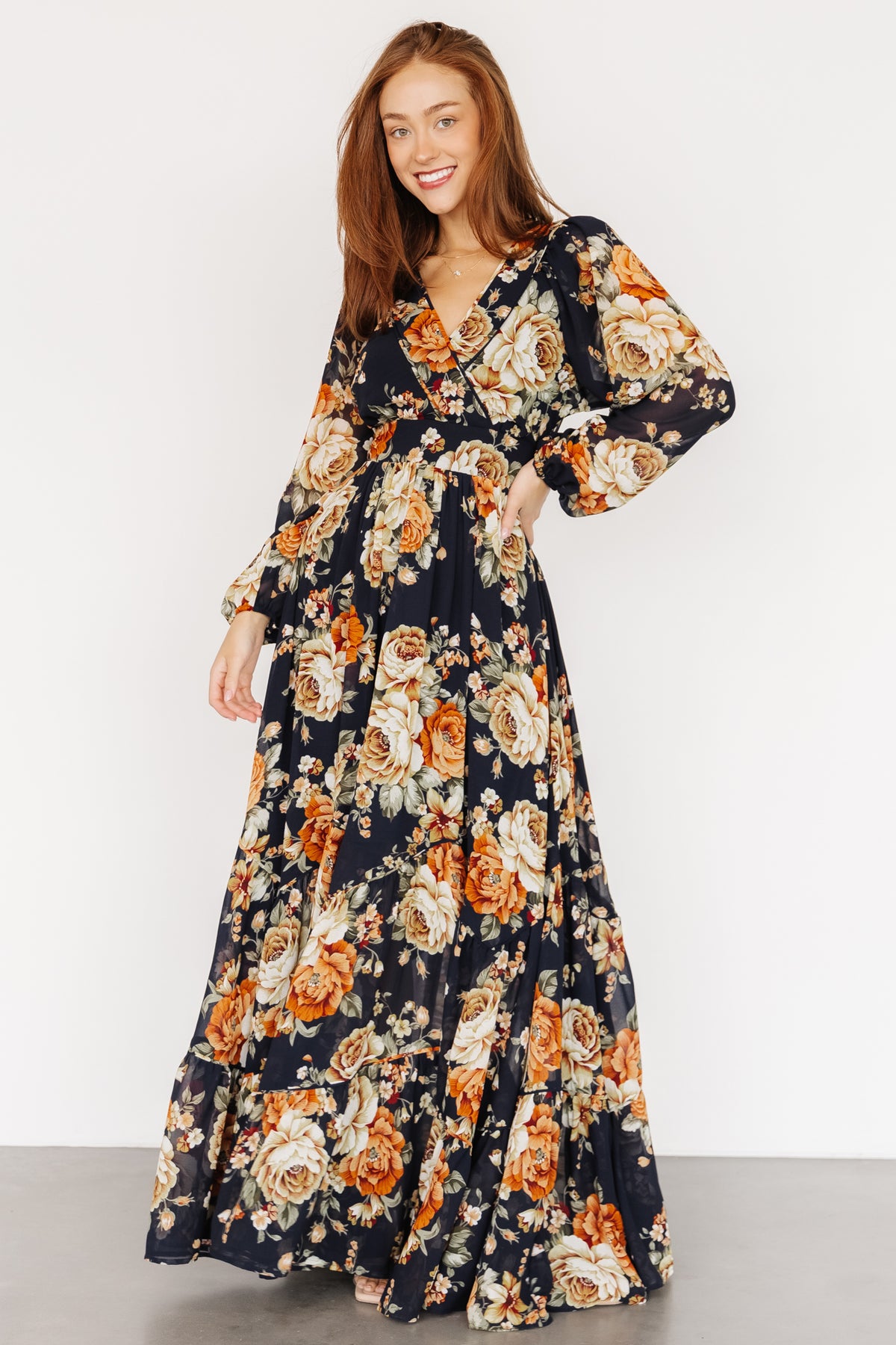 Three-quarter view showing the Johanna dress's long airy sleeves with elastic cuffs and the back keyhole button detail.