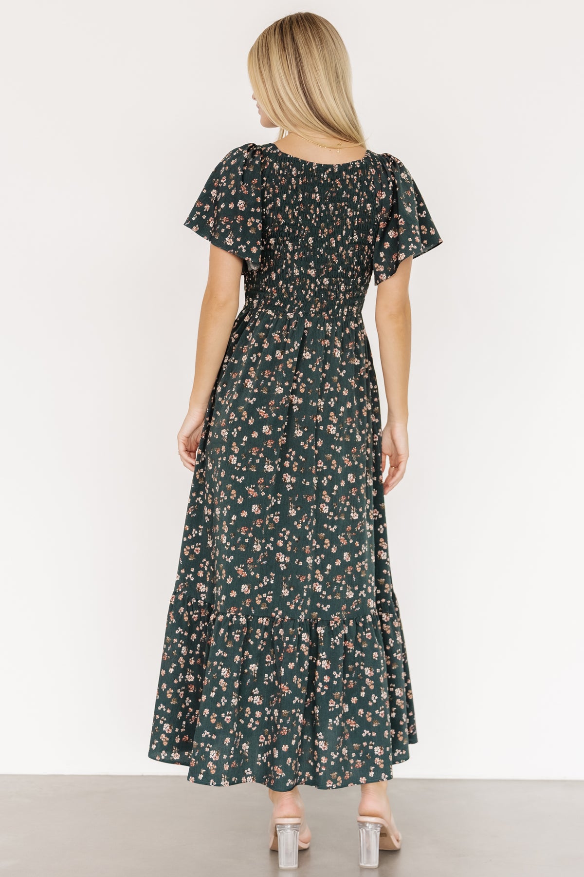 Side view showing the flutter sleeve detail with smocking at the shoulder and the dress's relaxed silhouette on a model.