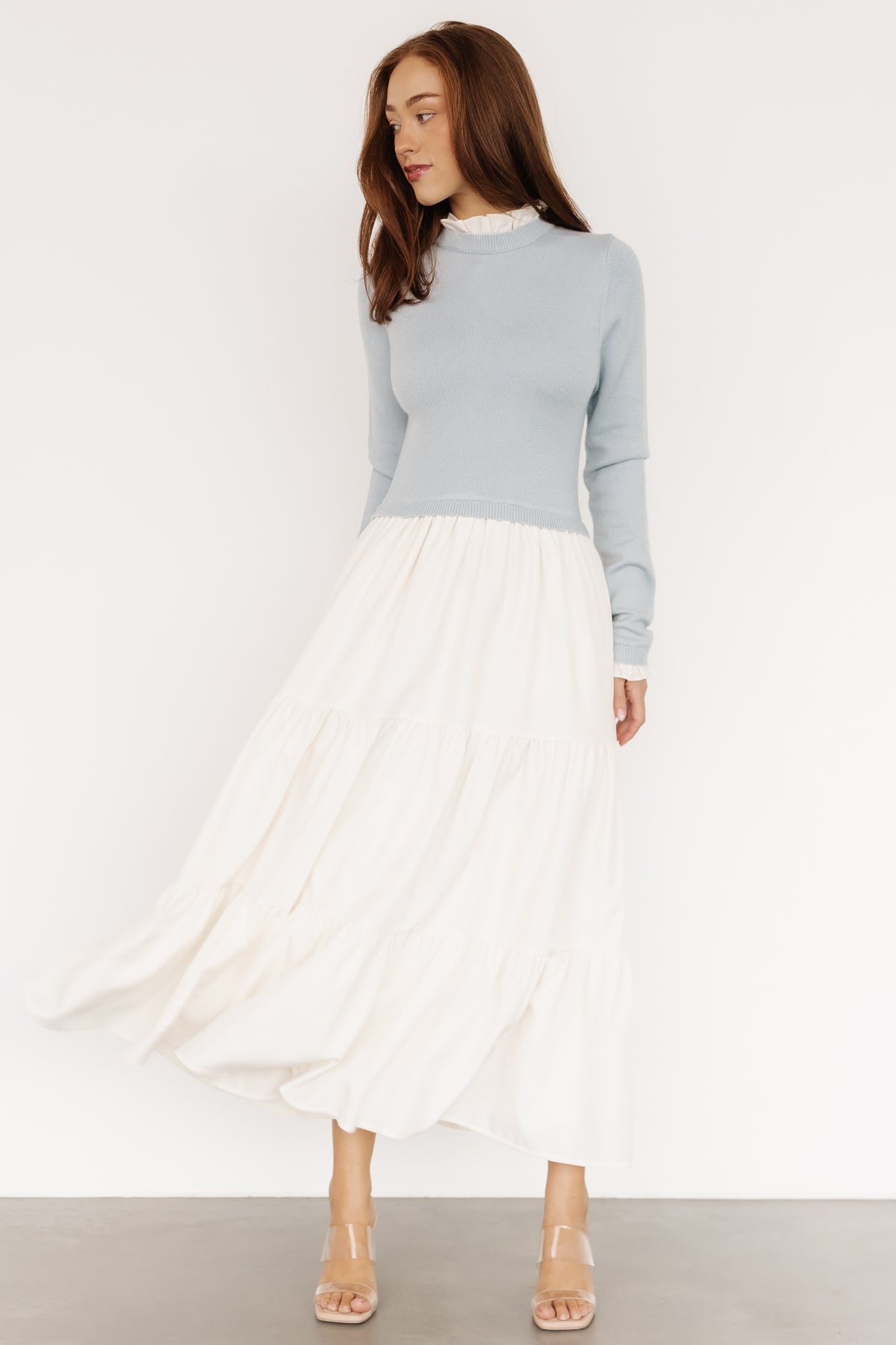 Model wearing Light Blue & Ivory Sophie Sweater Dress styled with neutral accessories, displaying overall fit, length, and feminine ruffle accents.