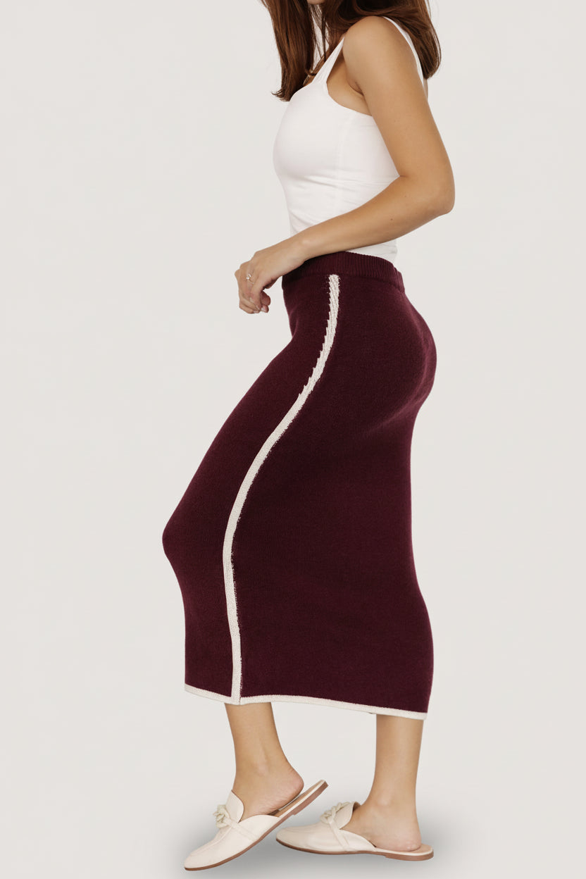 Back view of the Ava Knit Midi Skirt in wine on model, displaying elastic waistband, center back silhouette, and hem finish.