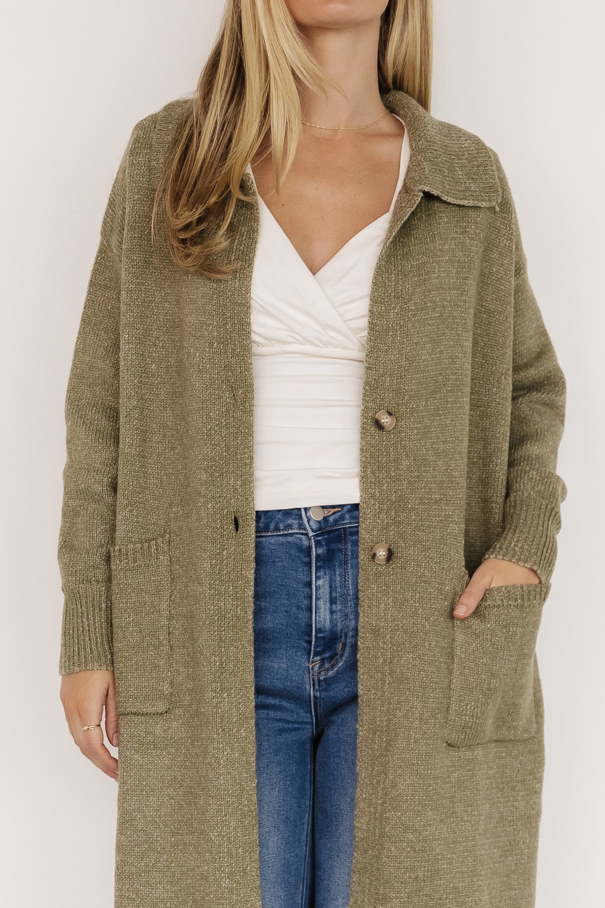 Close-up of wide ribbed collar, two-button closure, and knit texture on the heathered olive longline cardigan.