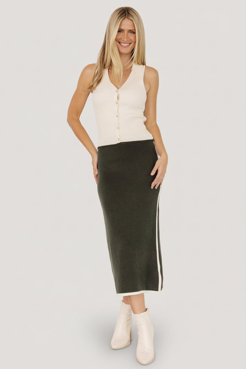 Detail close-up of knit texture and cream piping on the Ava Knit Midi Skirt, highlighting fabric weave and finishing at the hem.