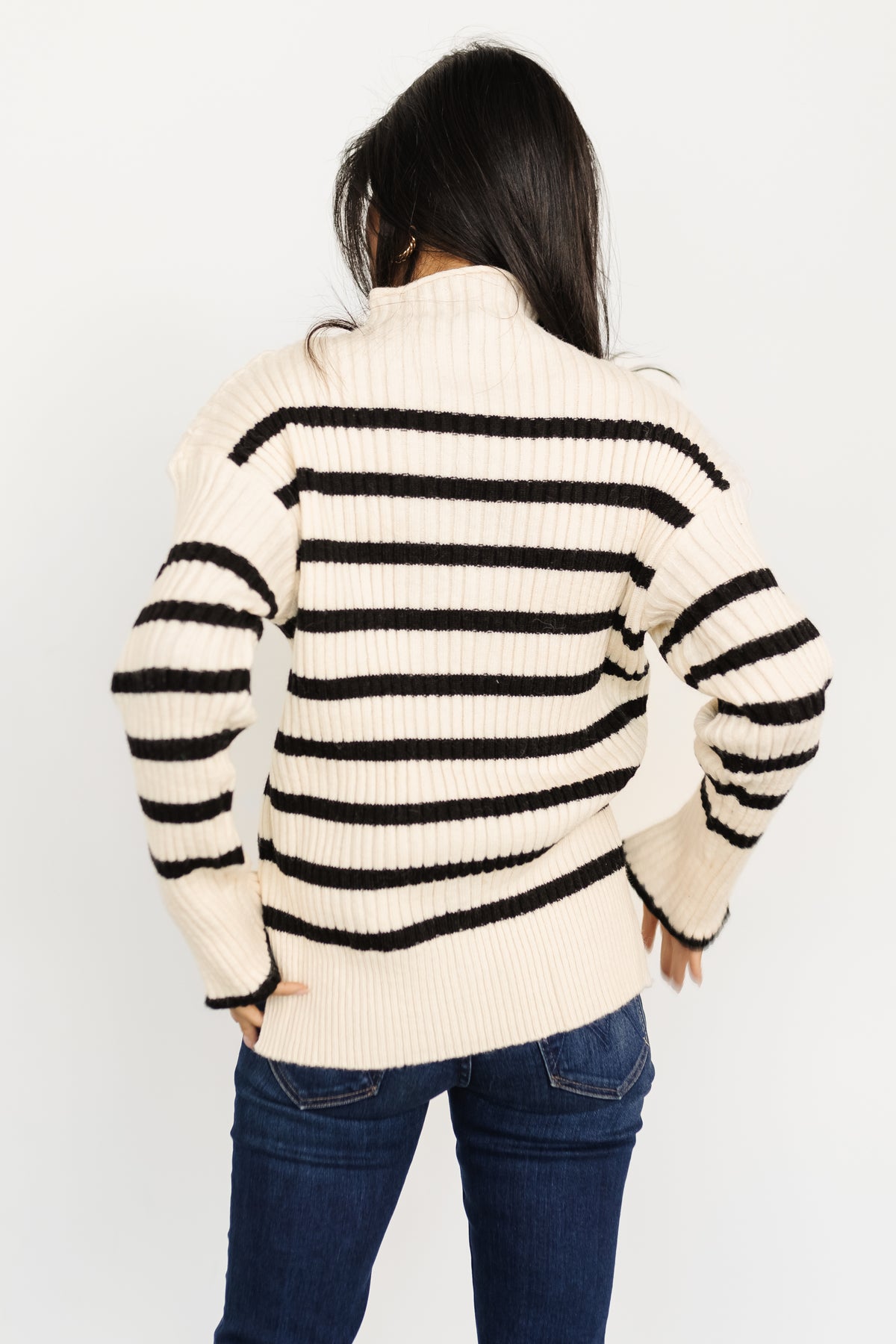Back and sleeve detail of ivory and black Landell sweater, showing ribbed finish and long sleeve proportions.