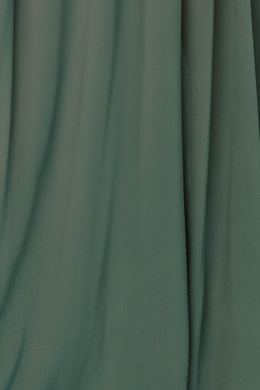 Close-up of Dark Sage Victoria chiffon fabric swatch on white background showing sheer, lightweight texture and soft drape for dressmaking.