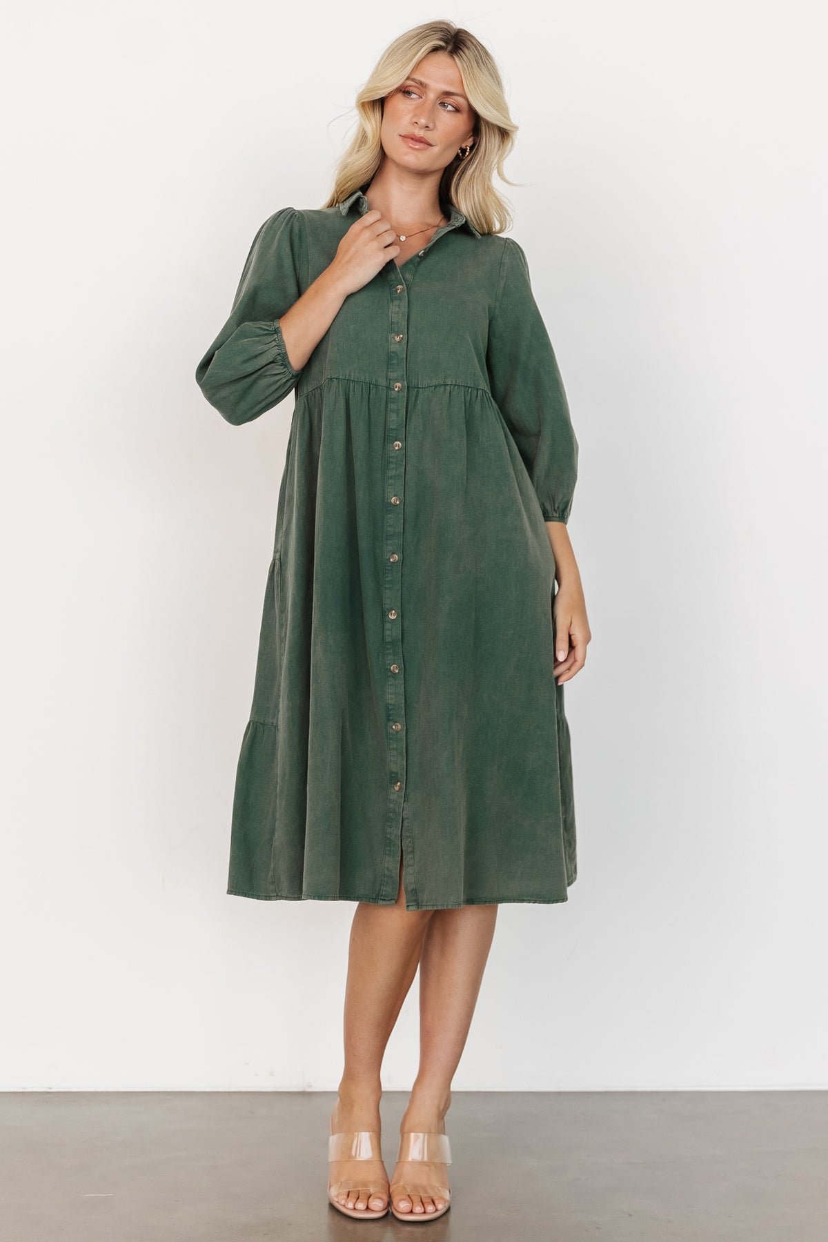 Casual styling shot of the green Sari Babydoll Dress paired with boots, showing length, movement, and easy everyday wearability.