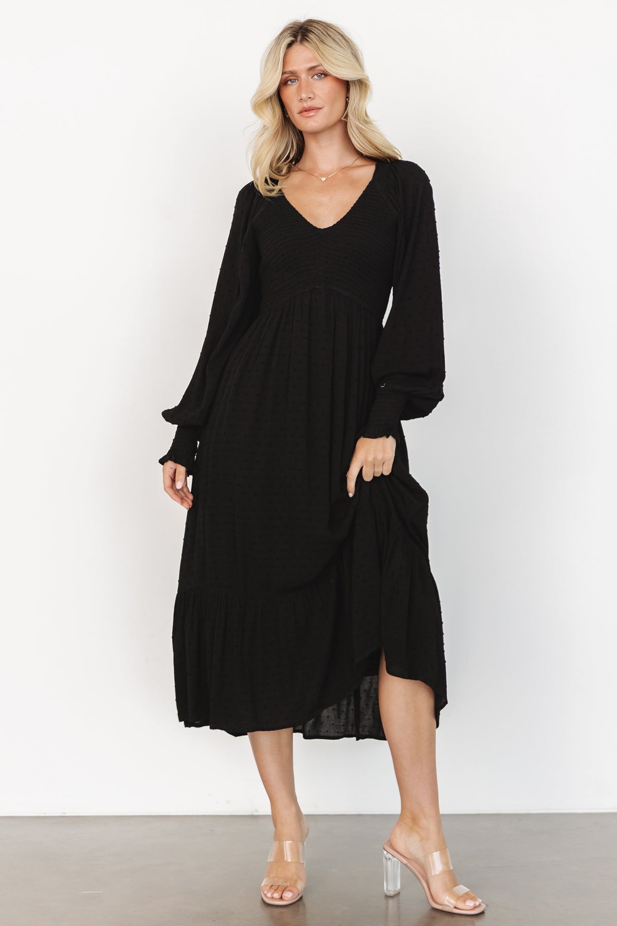 Detail close-up of dotted texture and fabric surface on the Lainey midi dress in black, showing weave, dot pattern, and lightweight rayon fibers.
