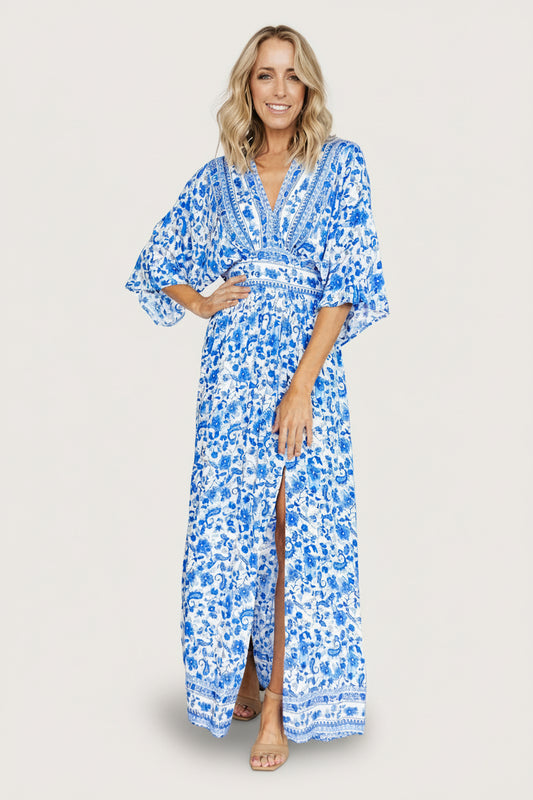Front view of Watson kimono maxi dress in blue and white print on model; V-neck, kimono sleeves, left slit.