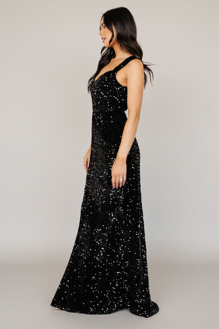 Studio shot of Monroe Velvet Sequin Gown in black on mannequin, showing silhouette, tank sleeves, and floor-length hemline.