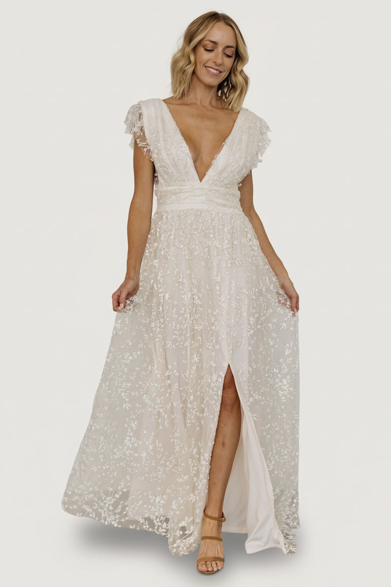 Detail of the banded waist and hidden zipper with hook-and-eye closure on the Arlene Shimmer Maxi Gown in ivory.