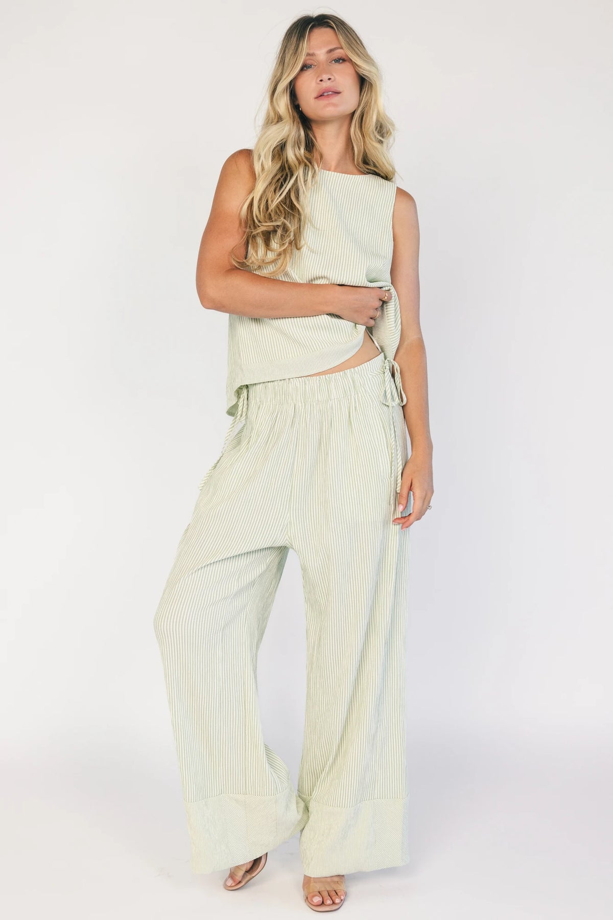 Sage striped matching set with a sleeveless open-back tie top, wide-leg pants, smocked waistband, side pockets, and a relaxed fit.