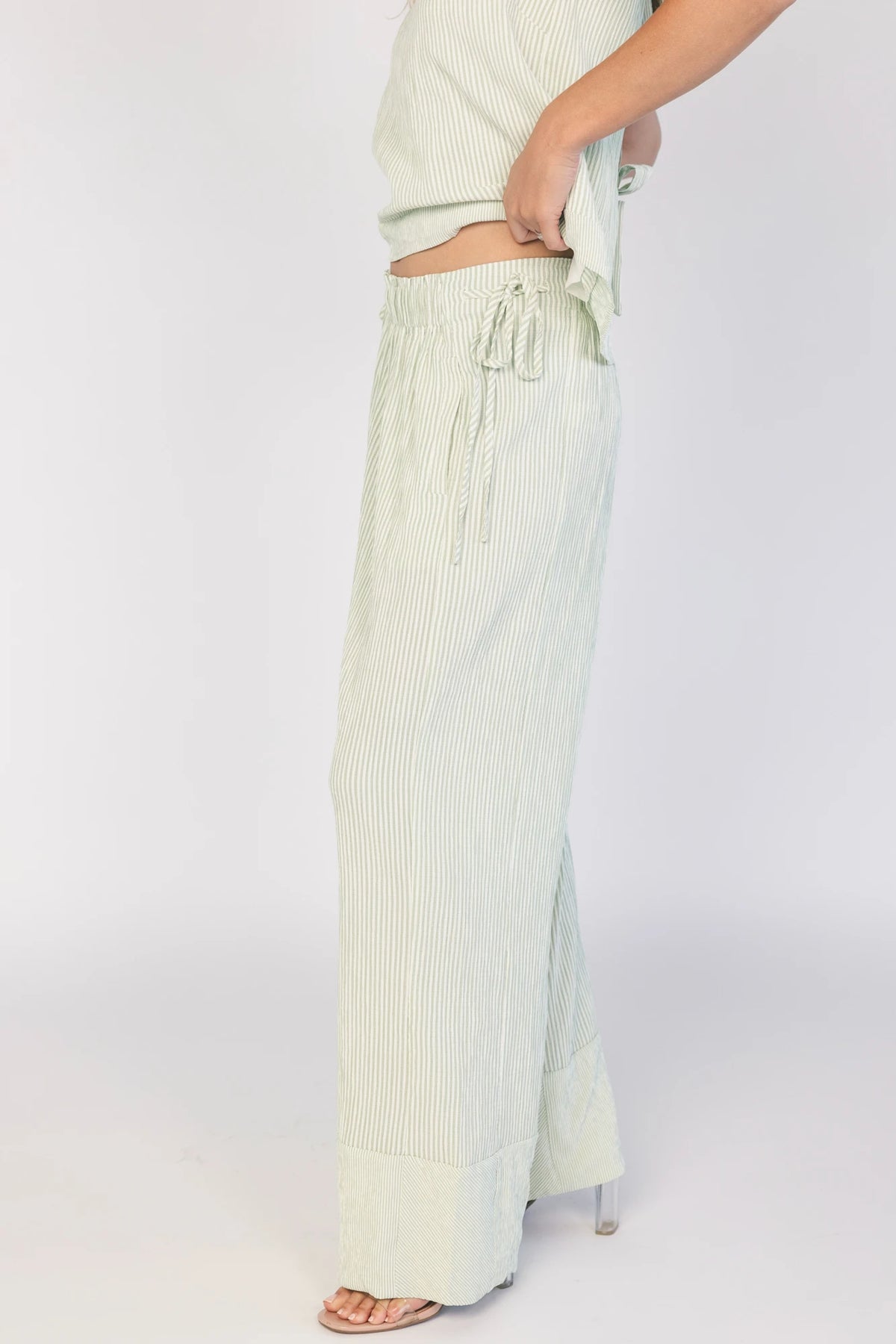 Sage striped matching set with a sleeveless open-back tie top, wide-leg pants, smocked waistband, side pockets, and a relaxed fit.