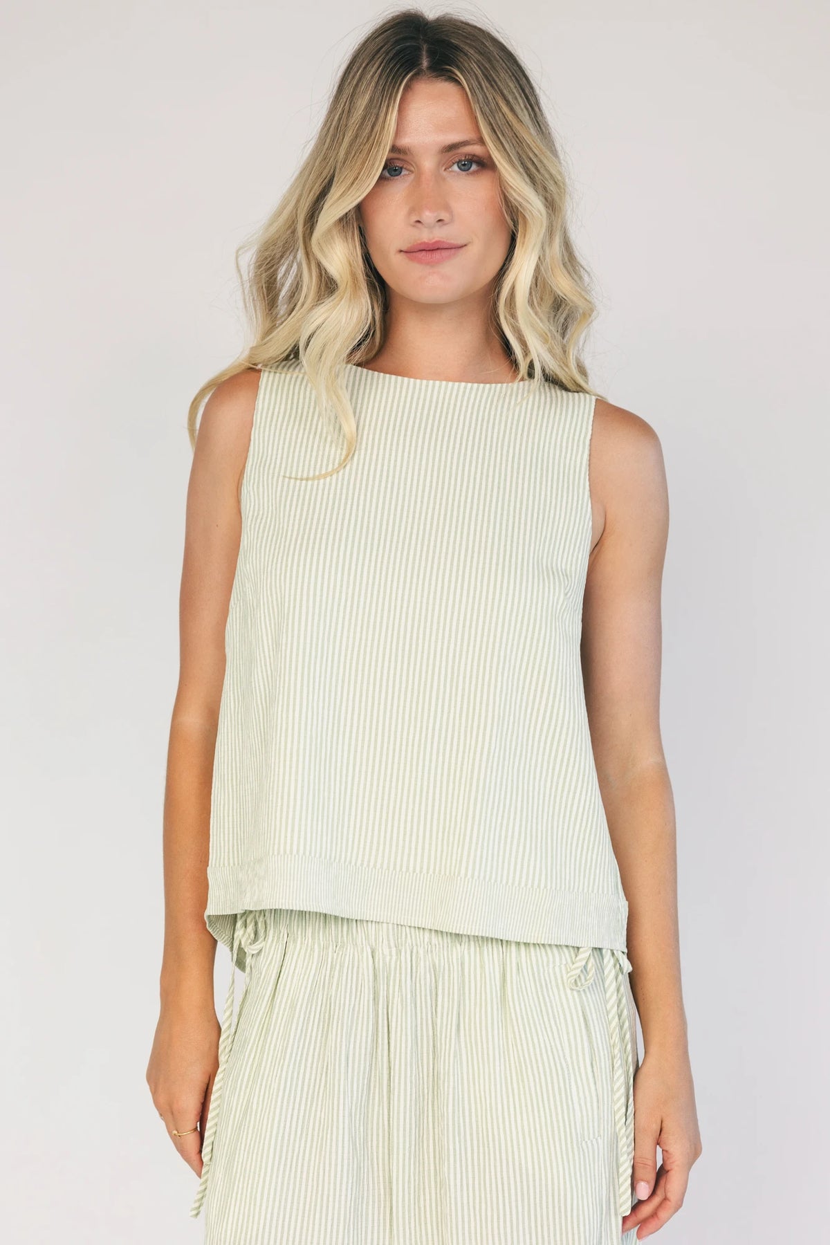 Sage striped matching set with a sleeveless open-back tie top, wide-leg pants, smocked waistband, side pockets, and a relaxed fit.