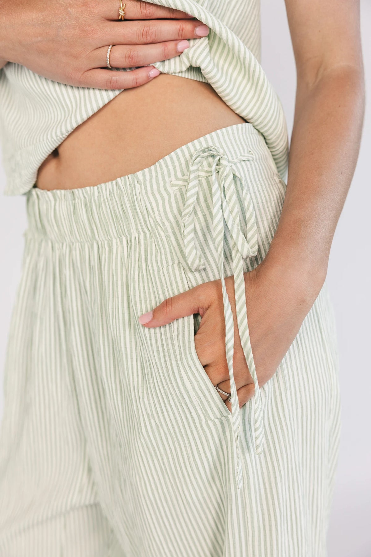 Sage striped matching set with a sleeveless open-back tie top, wide-leg pants, smocked waistband, side pockets, and a relaxed fit.