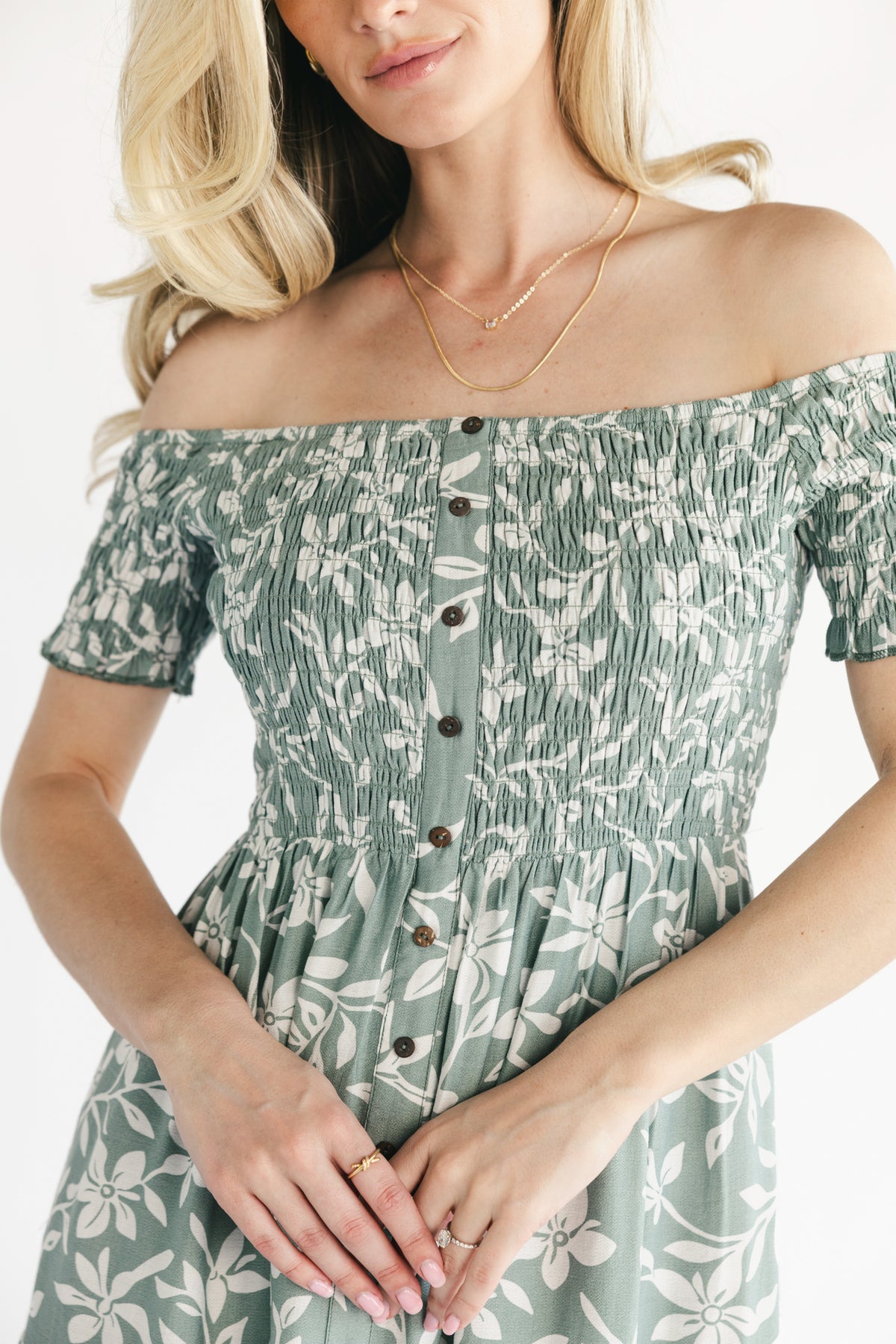 Three-quarter view of dusty sage Payton maxi dress highlighting short sleeves, off-shoulder elastic neckline, and tiered skirt movement.