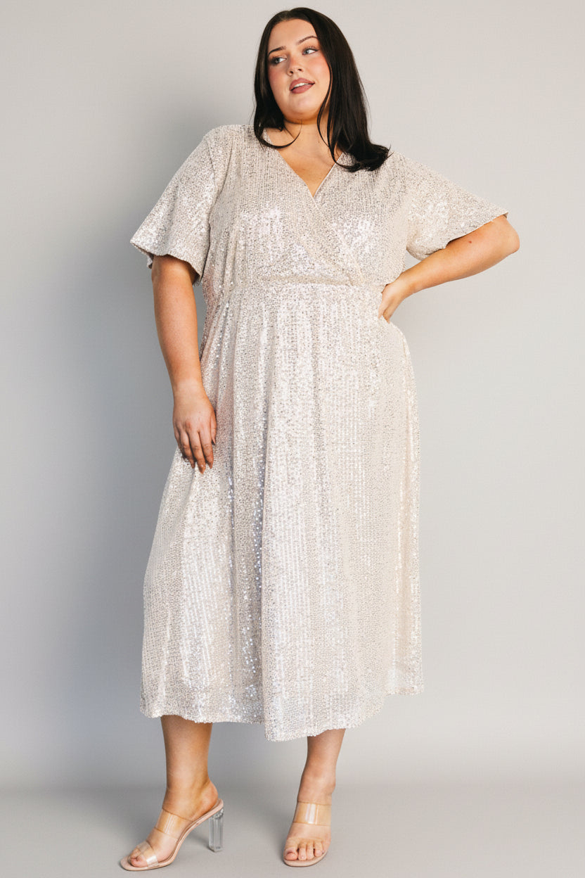 Side view of Mayfair Sequin Midi Dress on model showing mid-length skirt, elastic waistband, and shimmering sequin detail.