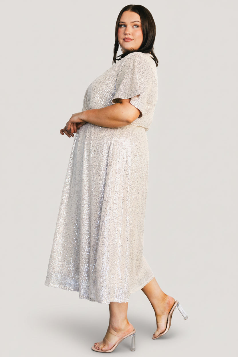 Detail of elasticized waistband showing stretch and shaping, with sequin placement and mesh-to-lining transition.