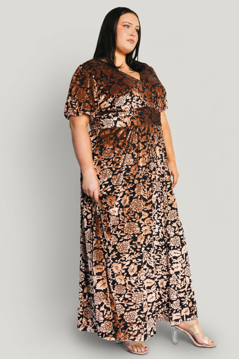 Styled look of Leslie velvet maxi dress in Black + Bronze with accessories, emphasizing occasion-ready styling and fabric sheen.