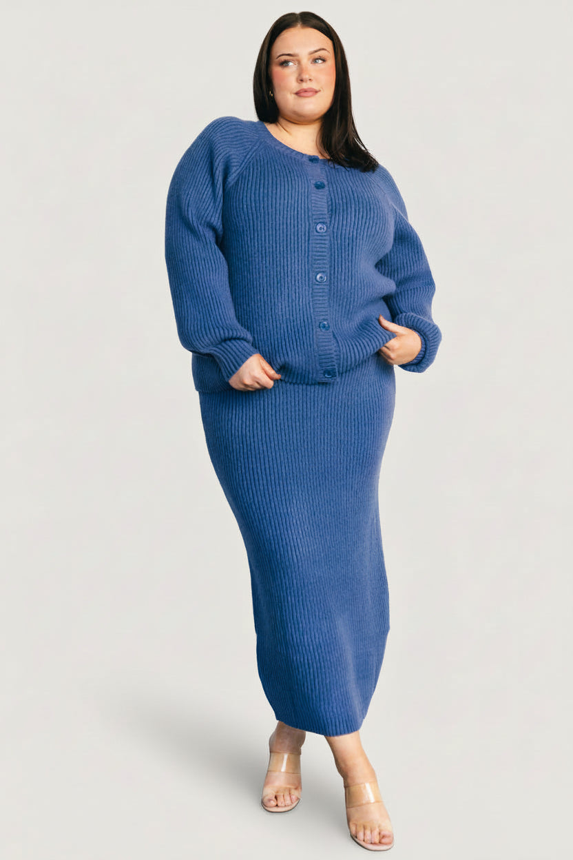 Side view of the Blair rib knit cardigan in blue on model, highlighting sleeve length and fitted ribbed cuffs.