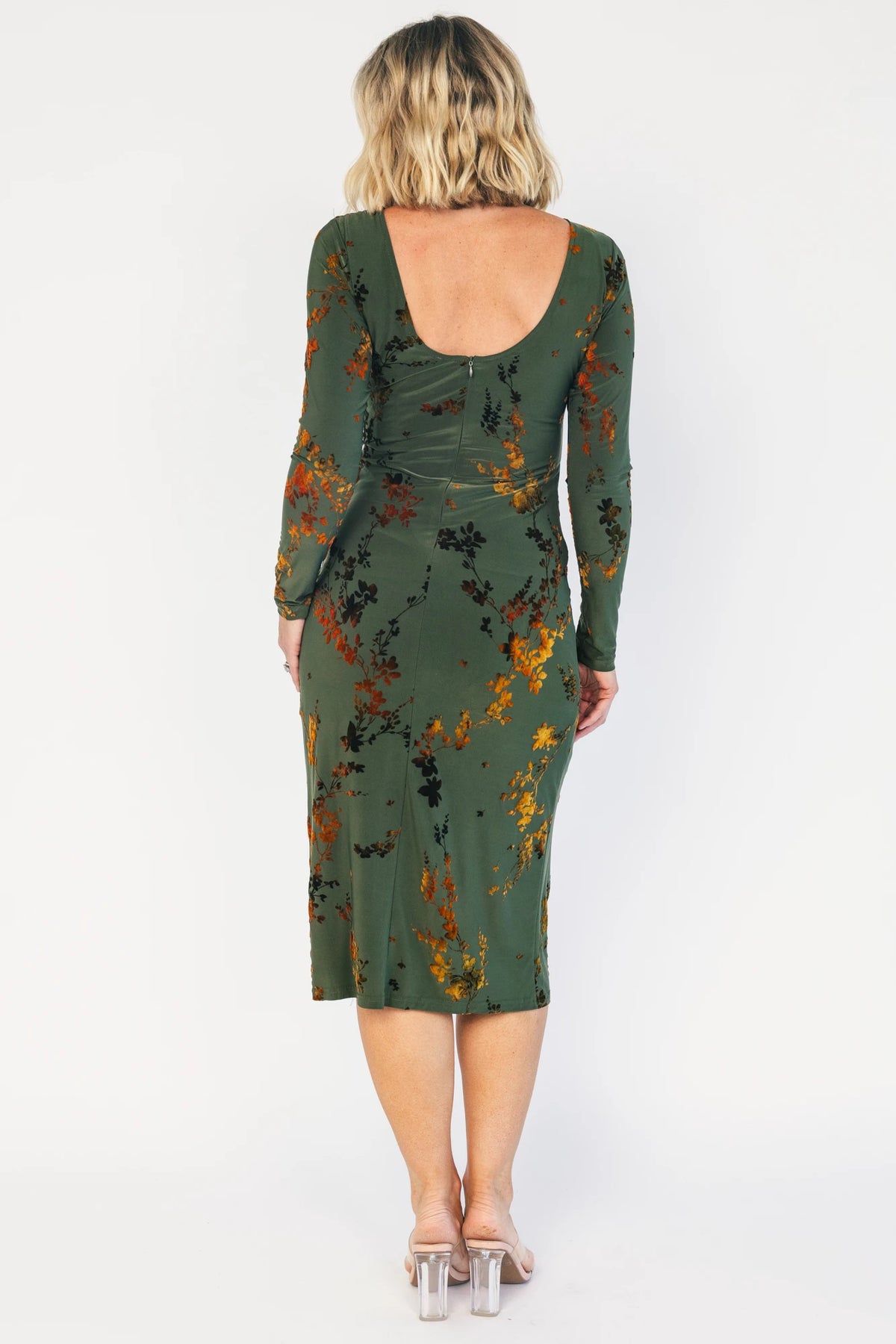 Green velvet floral midi dress with a boat neckline, long sleeves, side ruching, and a side slit.