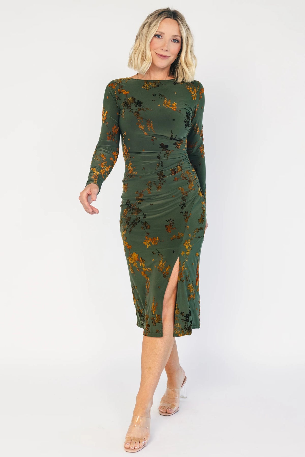 Green velvet floral midi dress with a boat neckline, long sleeves, side ruching, and a side slit.