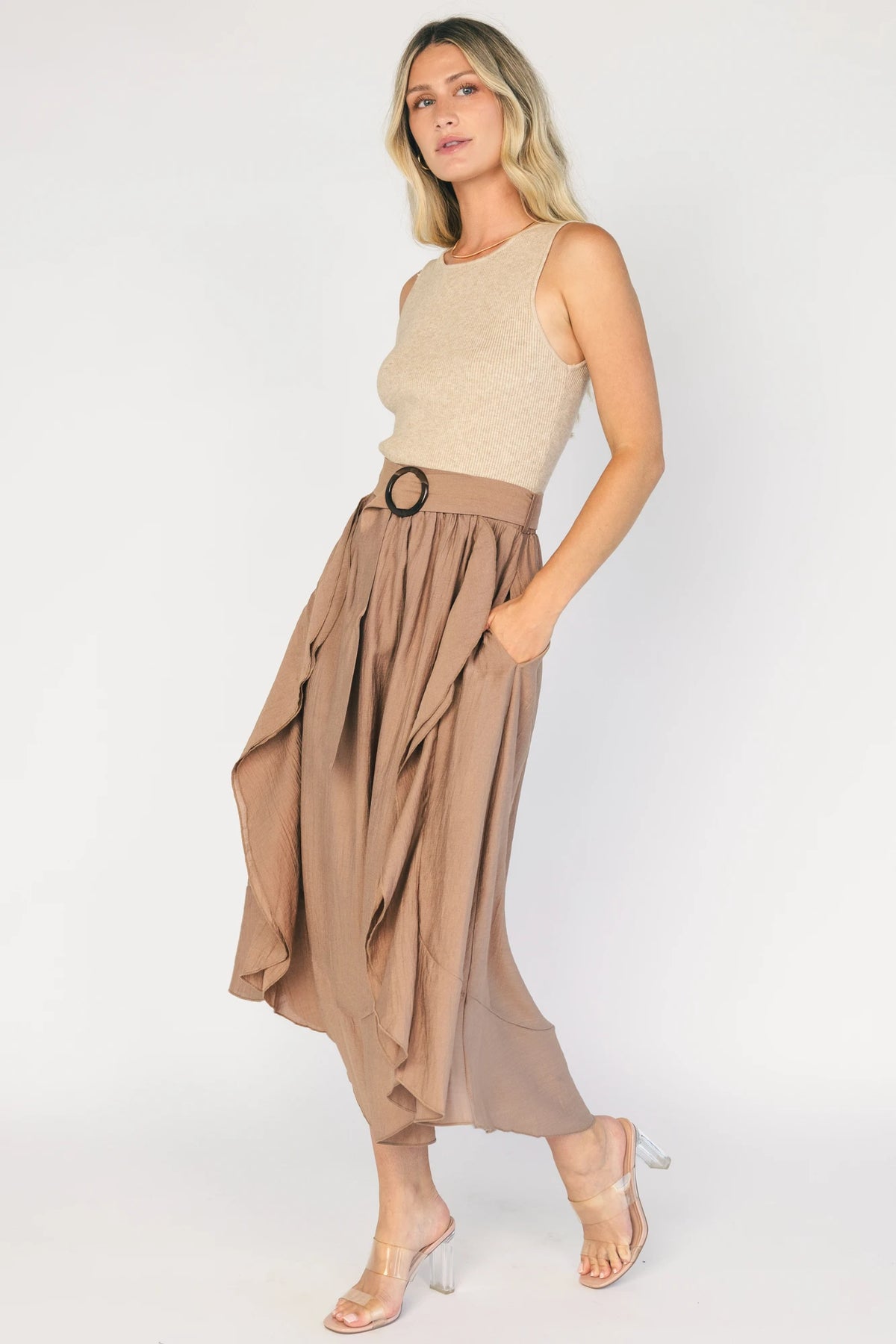 Model wearing the Stacy Midi Dress in Taupe + Mocha featuring a ribbed taupe knit bodice with a bateau neckline and a flowing woven midi skirt.