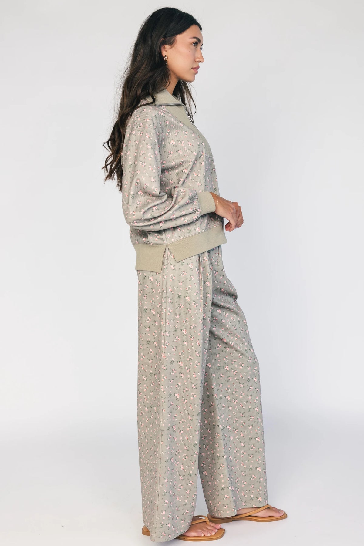 Model wearing the Diana Lounge Set in Olive Floral featuring a matching long-sleeve half-zip top and wide-leg pants.
