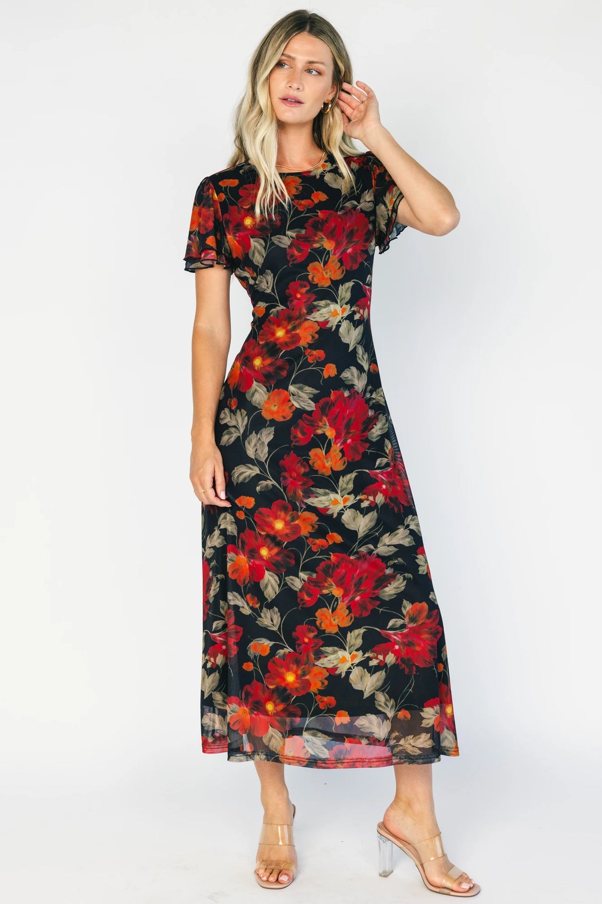 Black floral mesh maxi dress with a round neckline, layered flutter sleeves, bias-cut silhouette, and flowing full-length skirt.