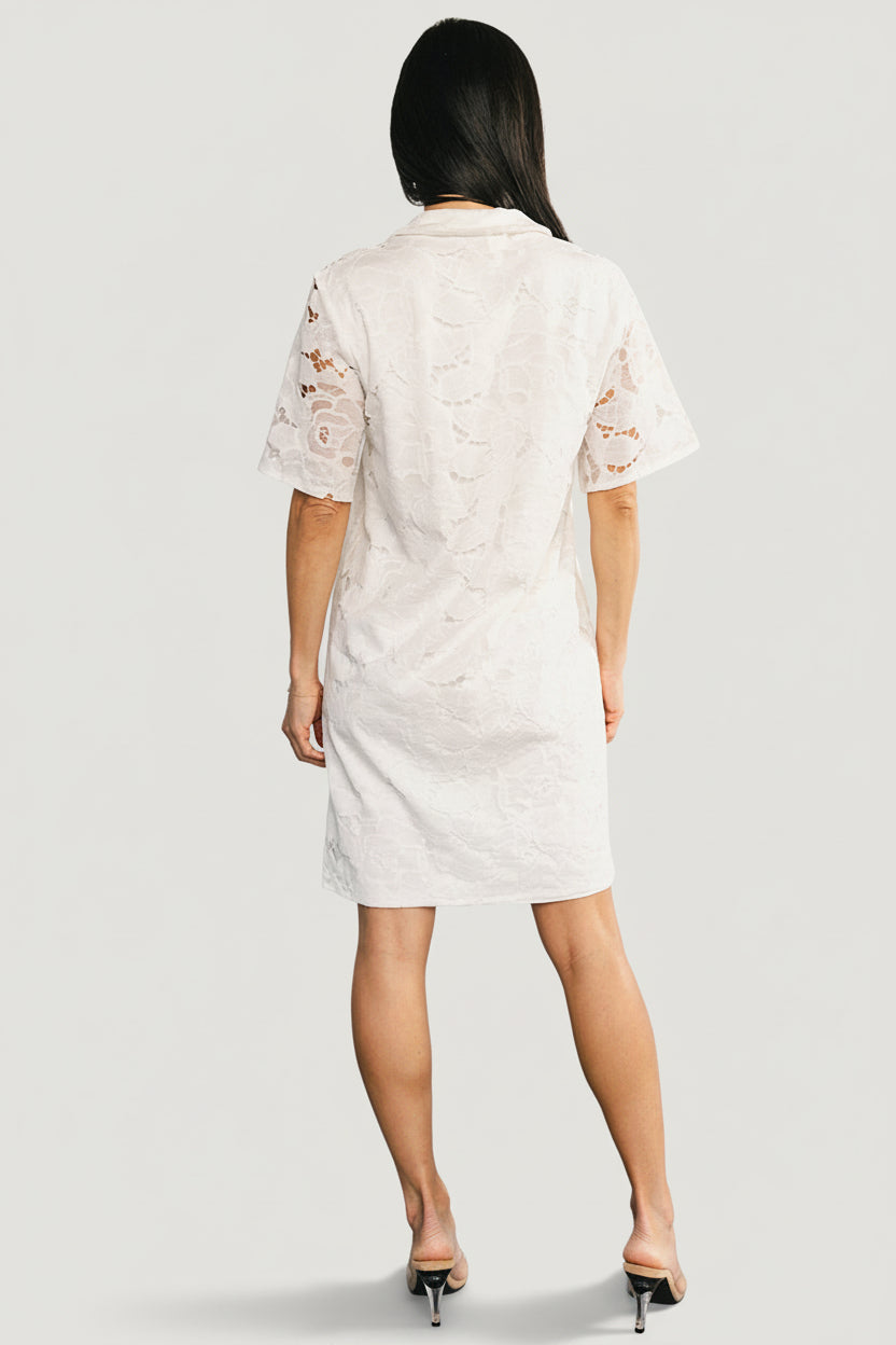 Close-up of Calida Lace Dress lace fabric and folded collar detail, showing delicate openwork and stitched lining at bodice.