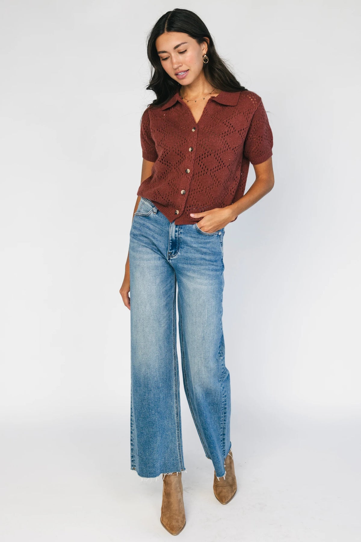 Model wearing a dark clay openwork knit cardigan with a V-neckline, short sleeves, five-button front closure, and a relaxed silhouette.