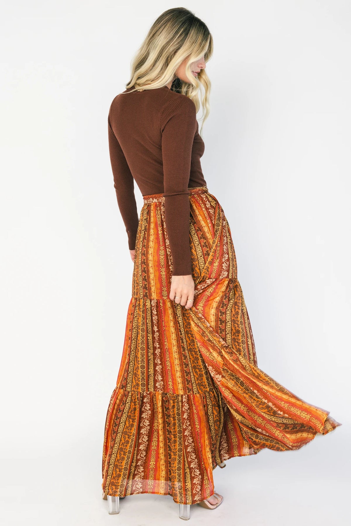 Brown ribbed sweater maxi dress with long sleeves, a high round neckline, removable waist tie, and a flowing multicolor chiffon skirt.