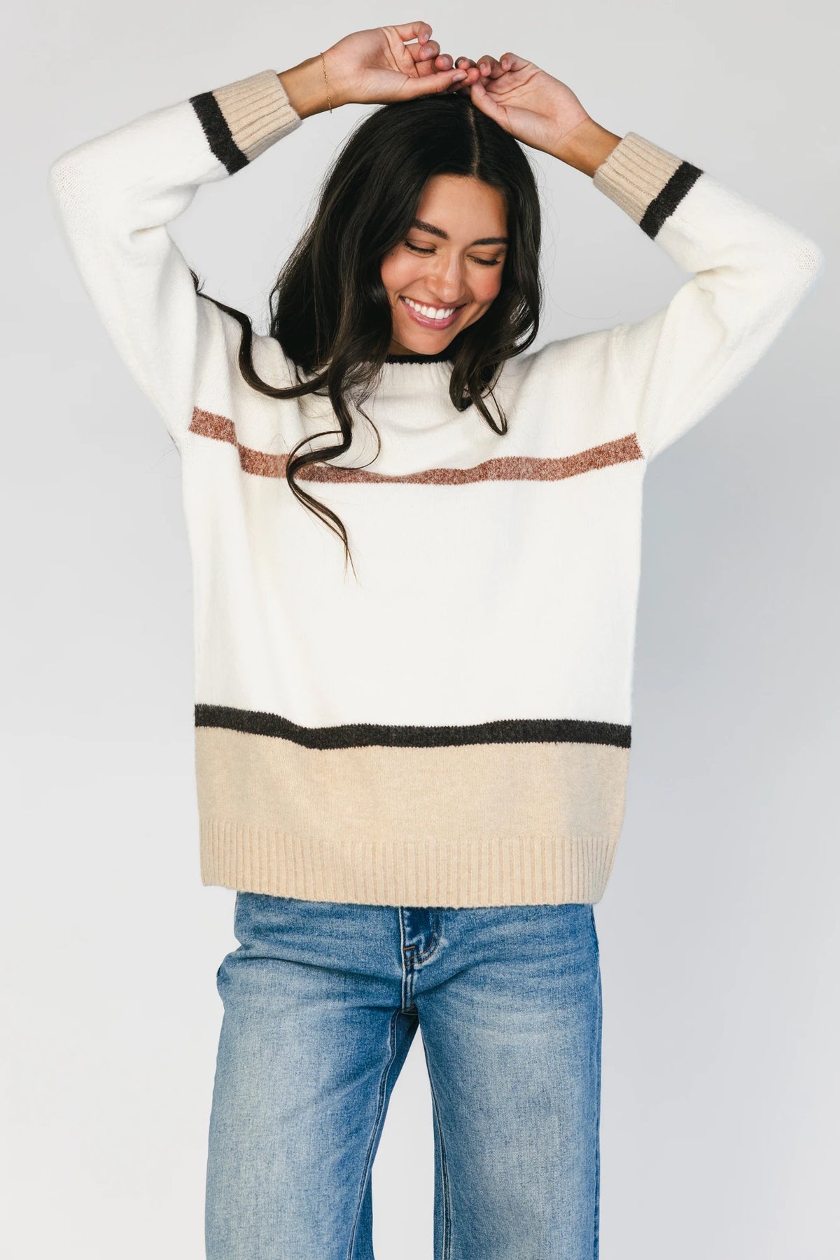 Natural color-block sweater with horizontal tan and brown stripes, a round neckline, long sleeves, and a relaxed fit.