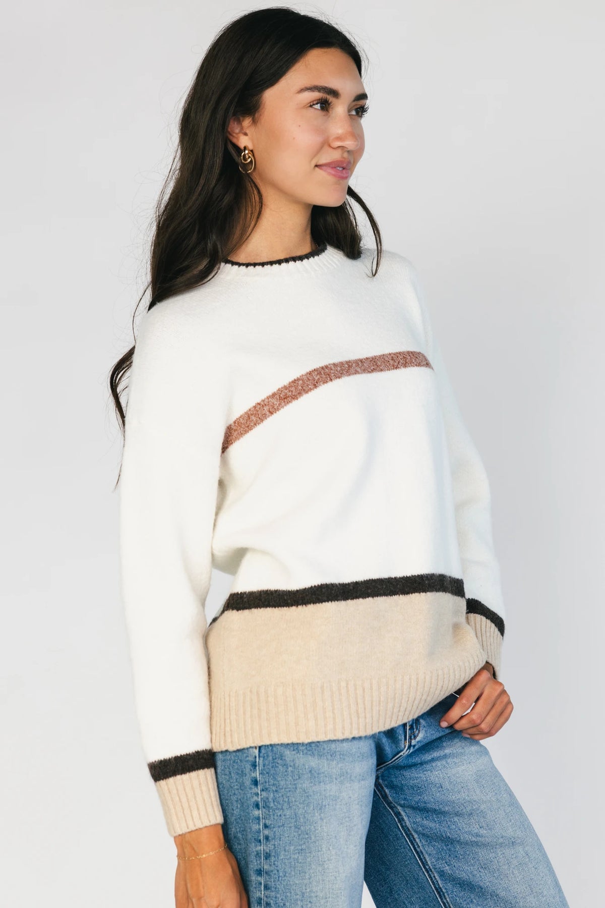 Natural color-block sweater with horizontal tan and brown stripes, a round neckline, long sleeves, and a relaxed fit.
