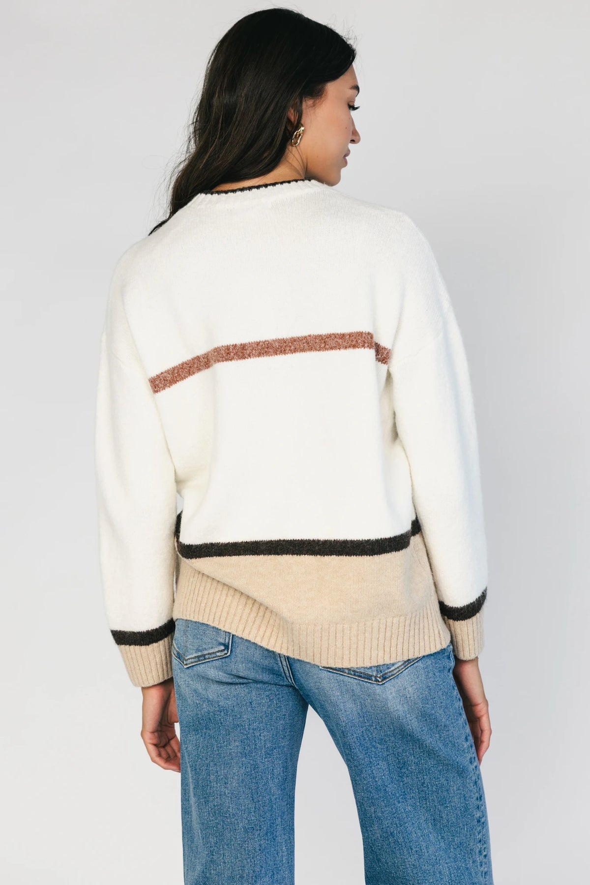 Natural color-block sweater with horizontal tan and brown stripes, a round neckline, long sleeves, and a relaxed fit.