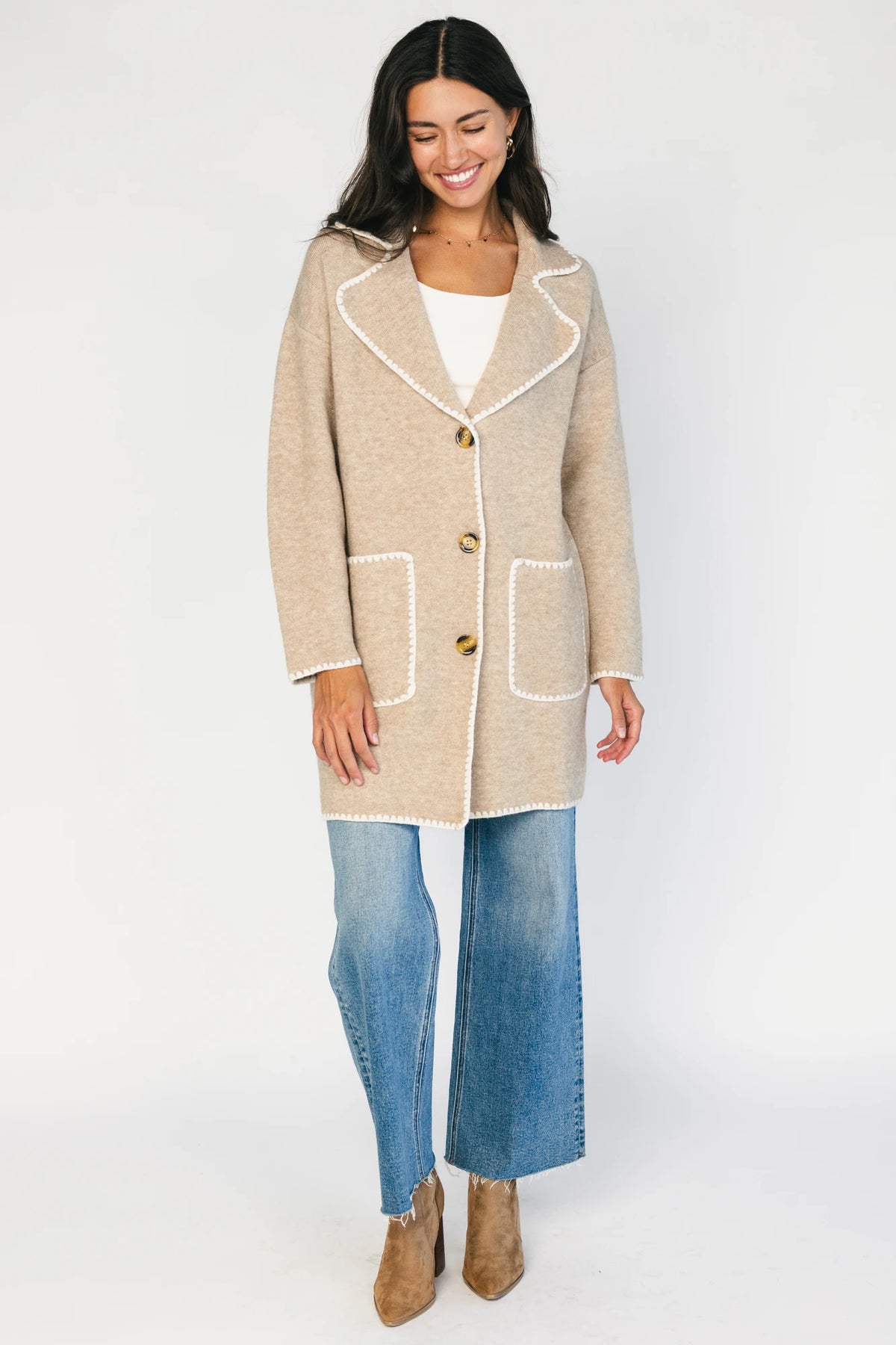 Taupe collared knit cardigan with cream contrast trim, a button-front closure, long sleeves, and two front patch pockets in a relaxed, shirt-style silhouette.