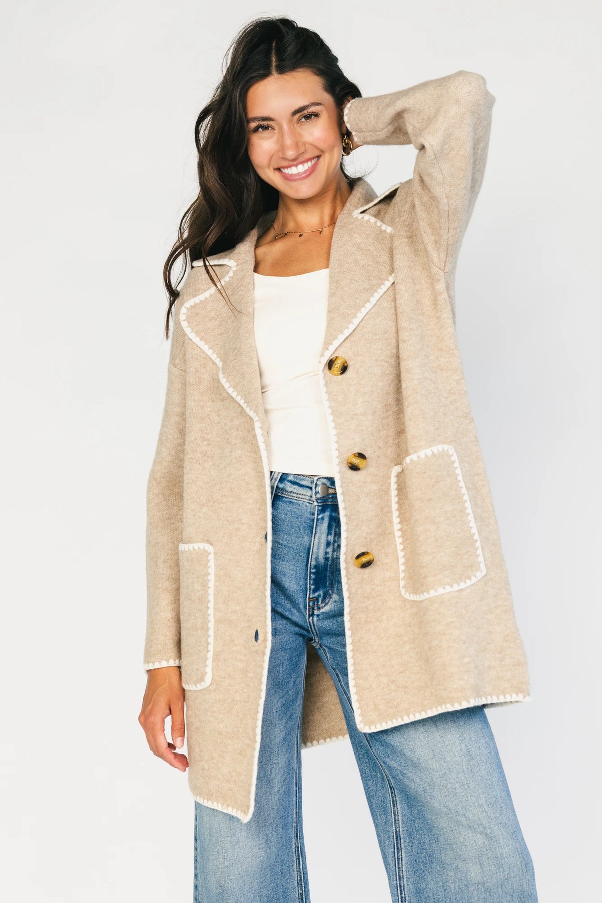 Taupe collared knit cardigan with cream contrast trim, a button-front closure, long sleeves, and two front patch pockets in a relaxed, shirt-style silhouette.