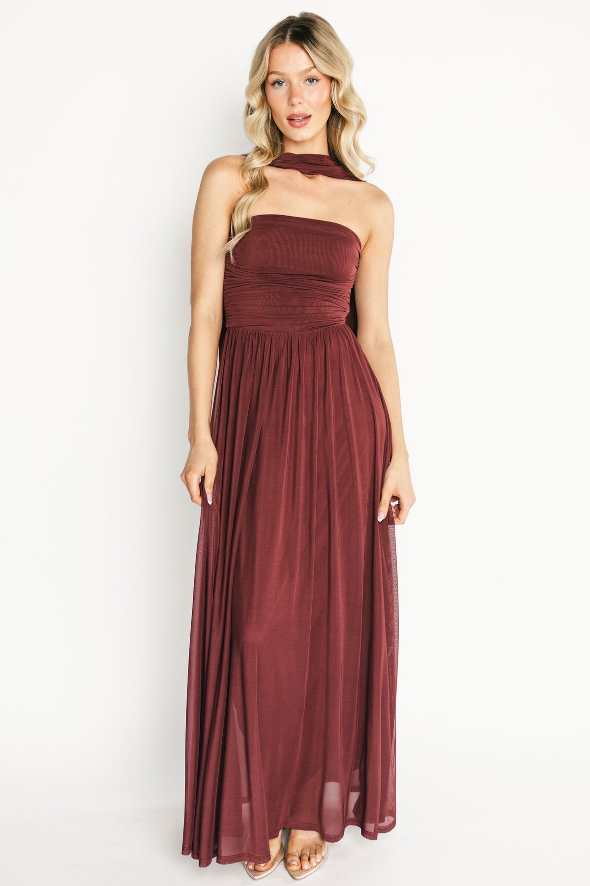 Front view of model wearing mahogany strapless Elias maxi dress with fitted bodice and neck scarf, floor-length hem.