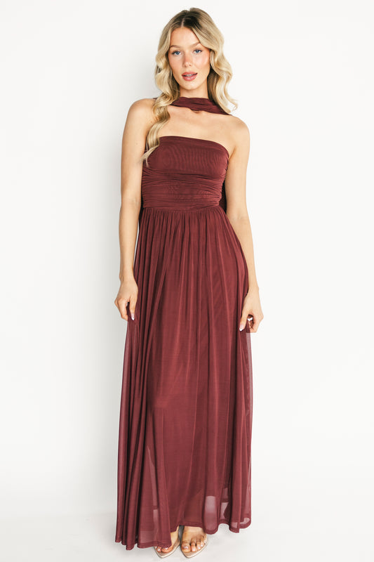 Front view of model wearing mahogany strapless Elias maxi dress with fitted bodice and neck scarf, floor-length hem.