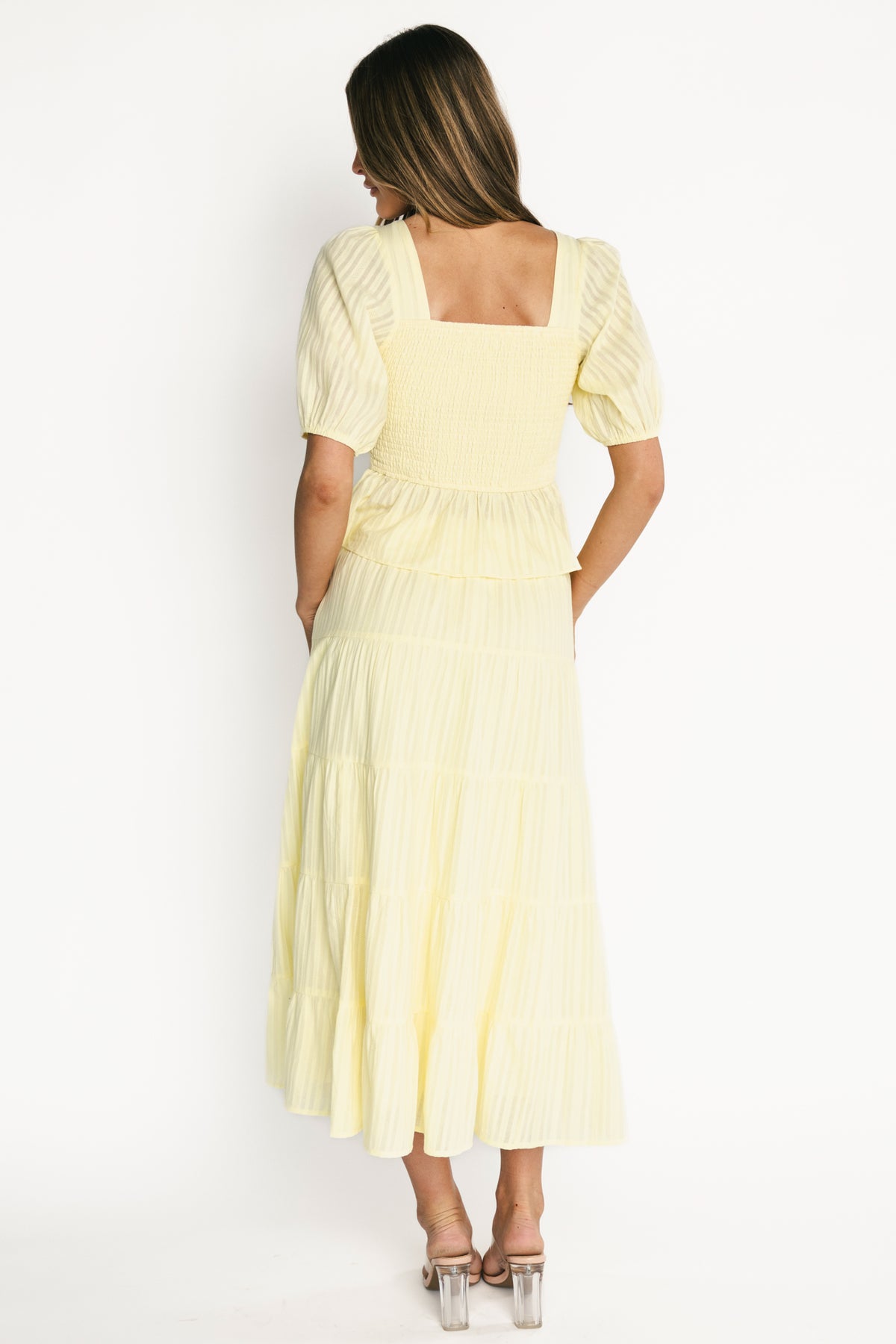 Styled shot of the full Candace two-piece on a model, showing length, movement, and styling potential for spring events.