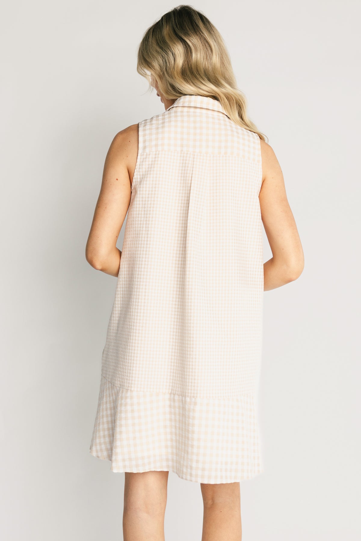 Model styling shot of the Dolly Short Dress paired with casual shoes, illustrating movement of the lined skirt, nursing-friendly button front, and comfortable silhouette.