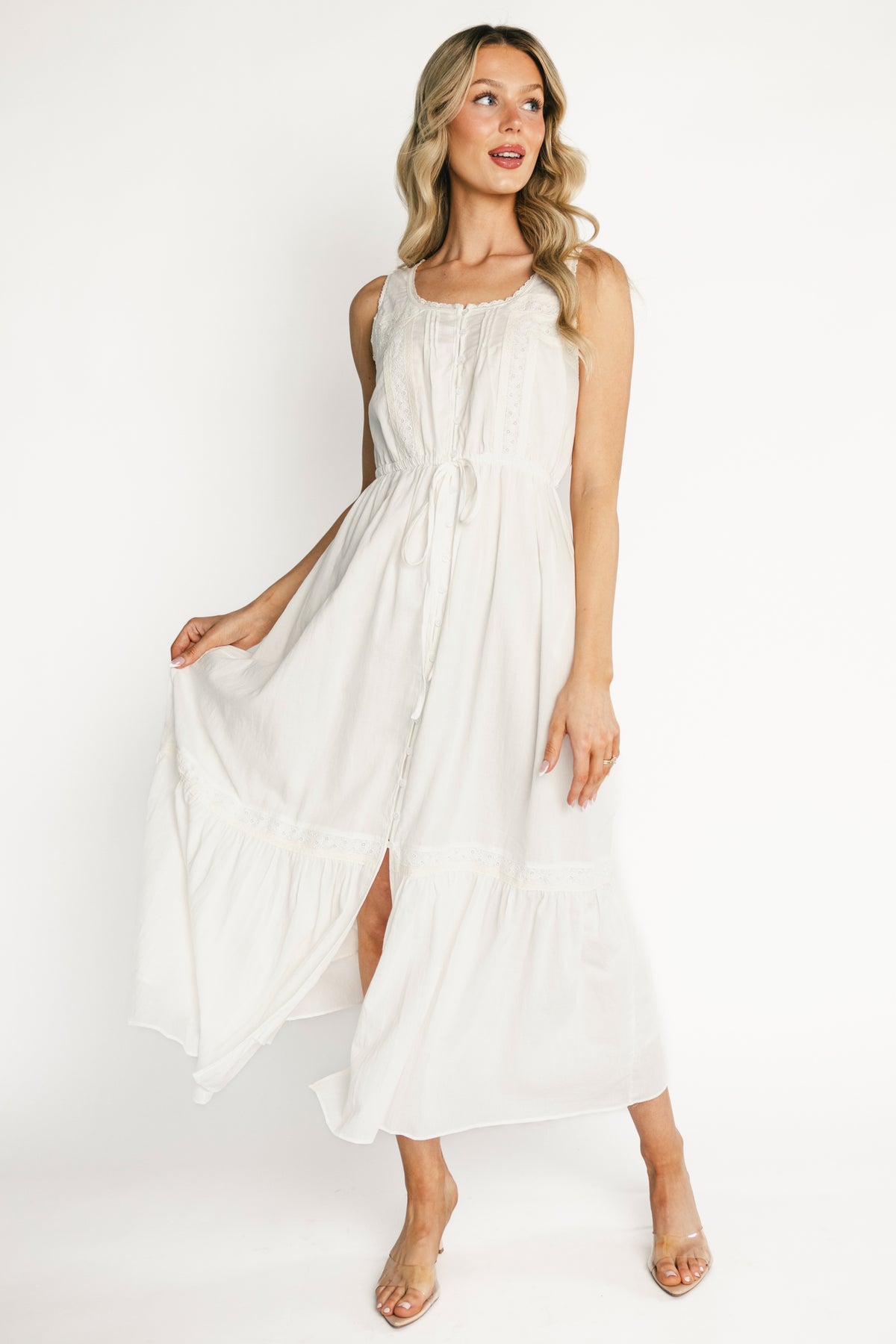Front view of Blanche midi dress in off-white cotton with lace-trim neckline, button-front bodice, and adjustable waist tie, shown on model.