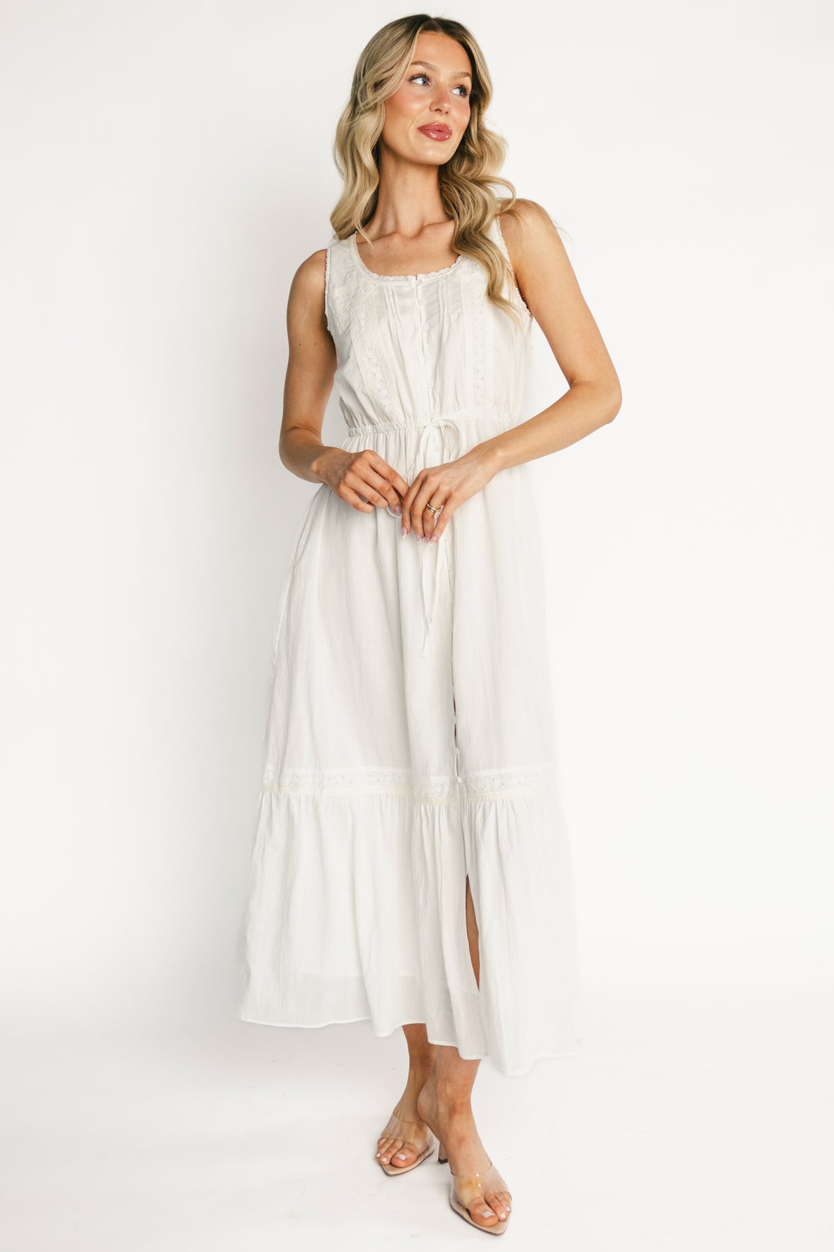 Detail image of skirt tiers and lace edging on off-white cotton fabric, illustrating lining coverage and lightweight drape.