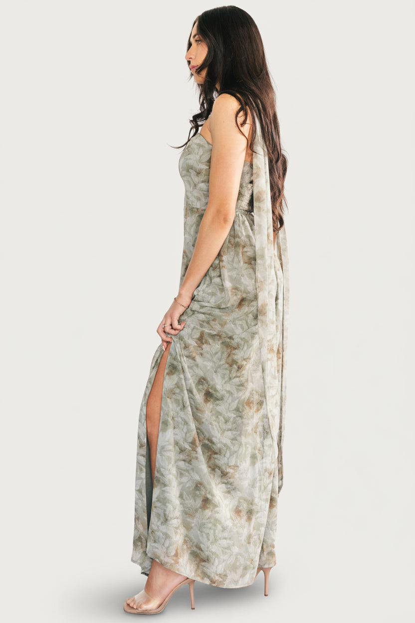 Model styling the removable waist sash as a neck scarf while wearing the Florian strapless maxi in eucalyptus floral print.