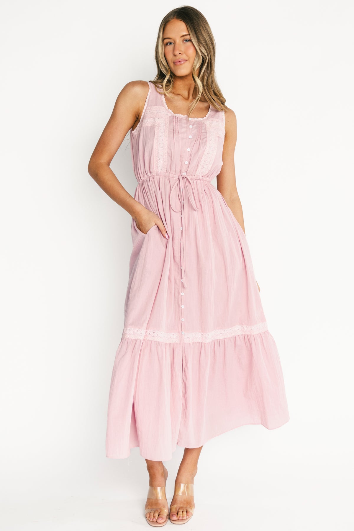Model wearing Blanche Midi Dress in primrose off-white — front view showing round neckline, lace trim, and button-front.