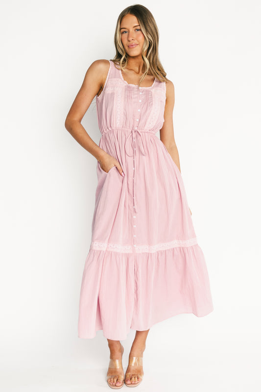 Model wearing Blanche Midi Dress in primrose off-white — front view showing round neckline, lace trim, and button-front.