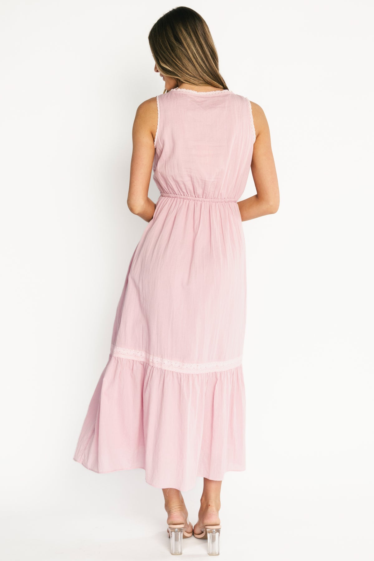 Detail of adjustable drawstring waist and tie showing cotton texture and fully lined interior of the midi dress.