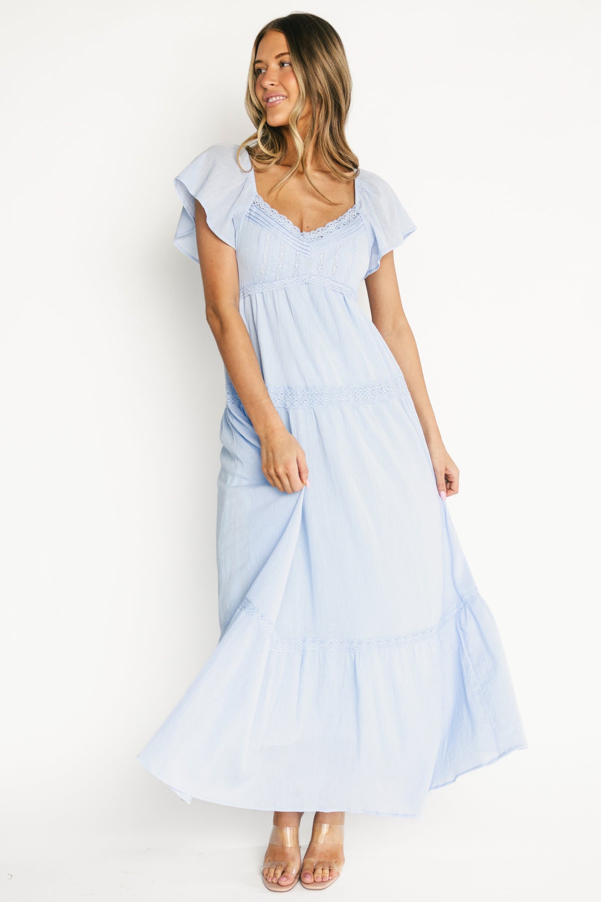 Front view of model wearing the Sabine Maxi Dress in soft blue, showing V-neckline, pintuck bodice, and delicate lace trim.